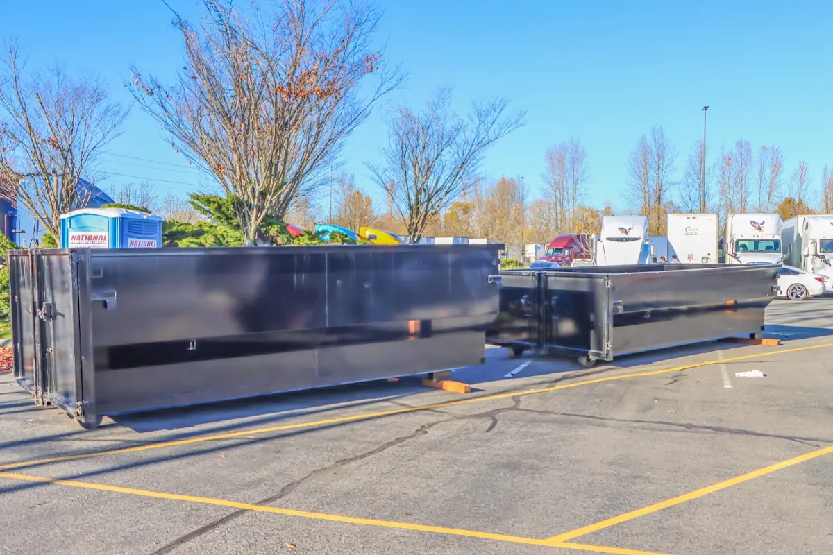 Professional dumpster rental service with roll-off container on residential driveway in Chalco